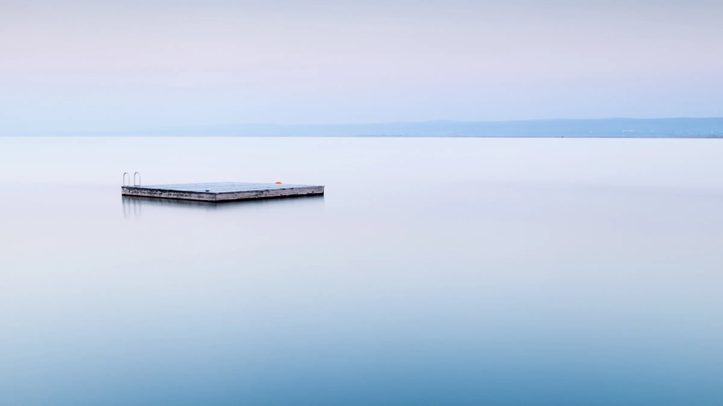 A concrete square floating in a calm sea