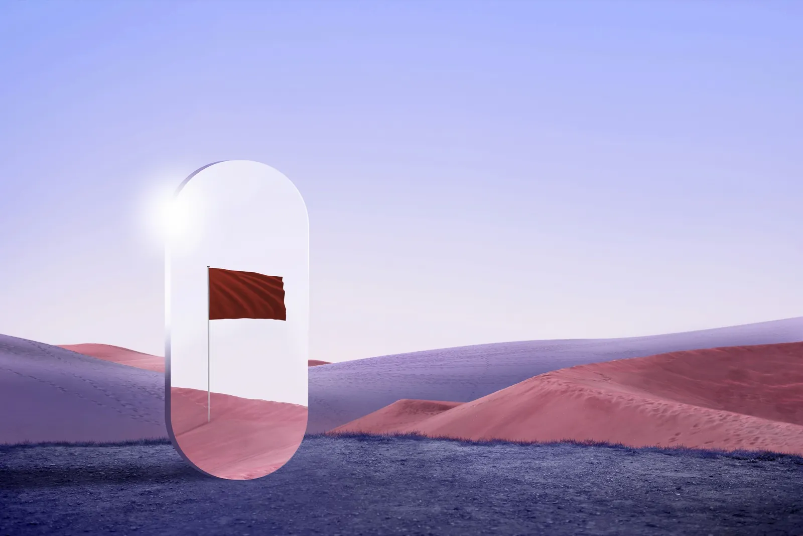 A red flag standing alone in pink dunes